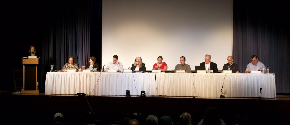 Town officials during Town Meeting on Monday, May 8, at Apponequet Regional High School. Officials, left to right, Town Moderator Kathryn Goodfellow, Town Clerk Lillian Drane, Town Counsel Michelle Randazzo, Select Board Chair Brian Day, Select Board Vice Chair Lorraine Carboni, Select Board Member Evagelia Fabian, Town Administrator Ari Sky, Town Accountant Todd Hassett, Finance Committee Chair Christopher Plonka, and Finance Committee Member Lawrence Kostant. Photo by Rusty Gorelick