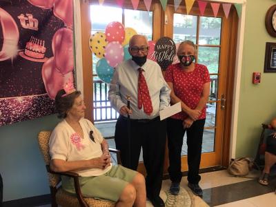 The Boston Post Cane, awarded to the community’s oldest resident, was presented to Elizabeth Bryant by Brian Reynolds, center, president of the Lakeville Historical Society and chair of the Lakeville Historical Commission, and Joan Gladu Morton, vice president of the Lakeville Historical Commission and a member of the Lakeville Historical Society.