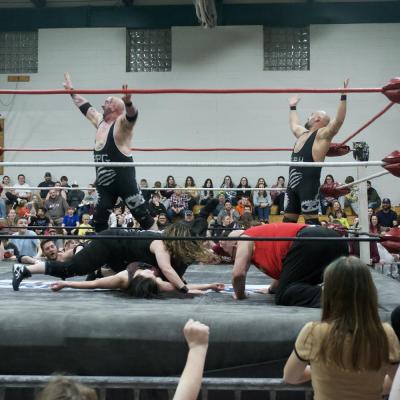 Powerful Pat Garrett (left) and the Portuguese Power House celebrate as guest referee and Burkland Elementary School Assistant Principal Greg Thomas’s hand hits the mat for the three-count.