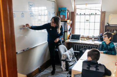 Megan O'Brien, a learning specialist, teaching literacy to two fifth graders. This is a typical structured literacy session for students in the Sally Borden Program. Source: Alicia Porter