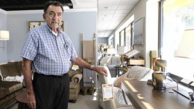 Bob Saquet stands next to a table in the show room at the store. He said he stands proud on the decades of fine-furniture he has sold to Middleboro residents and beyond.