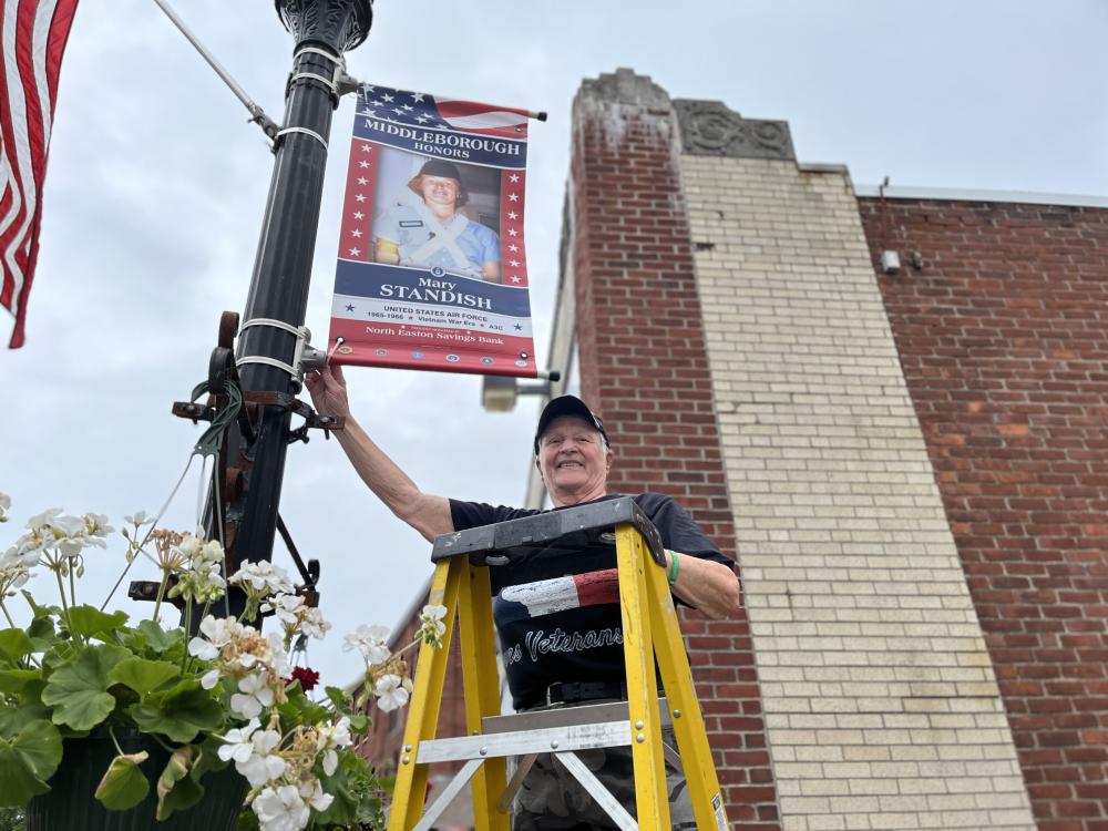 Mary Standish at the banner that bears her name. Photos by Sandy Quadros Bowles