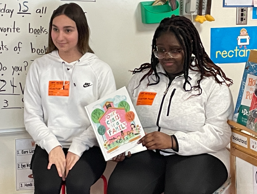 Danica Powers and Juliyah Vilbrun read “Our Class is a Family.’’