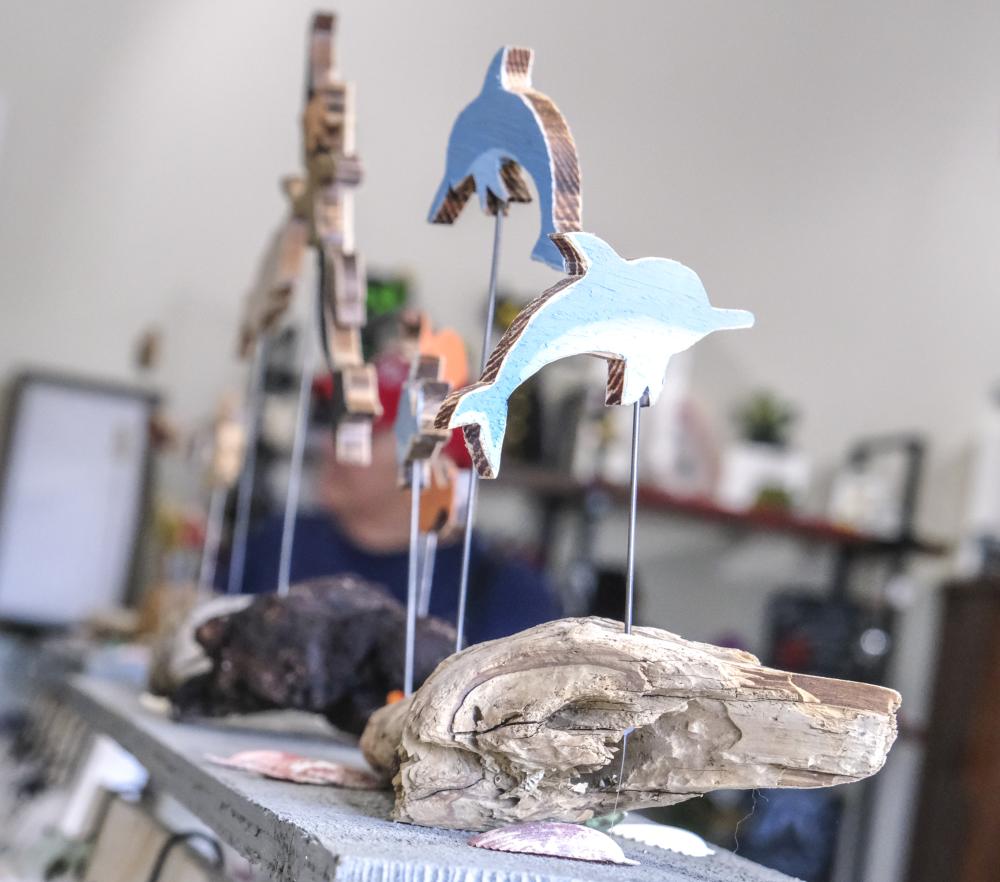 Art works made of wood-cut figurines and drift wood are displayed. ART