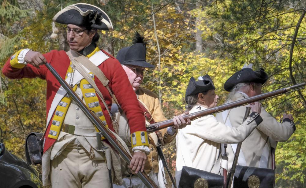Kyle Dunbar, left, loads a musket during a military drill at the colonial reenactment held at the Oliver Estate in Middleboro, Sunday, Oct. 19. Photos by Sam Tucker NONE