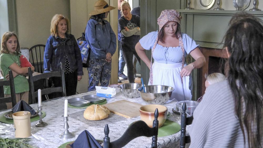 Attendees gather in a room of the estate to watch a bread making demonstration. NONE