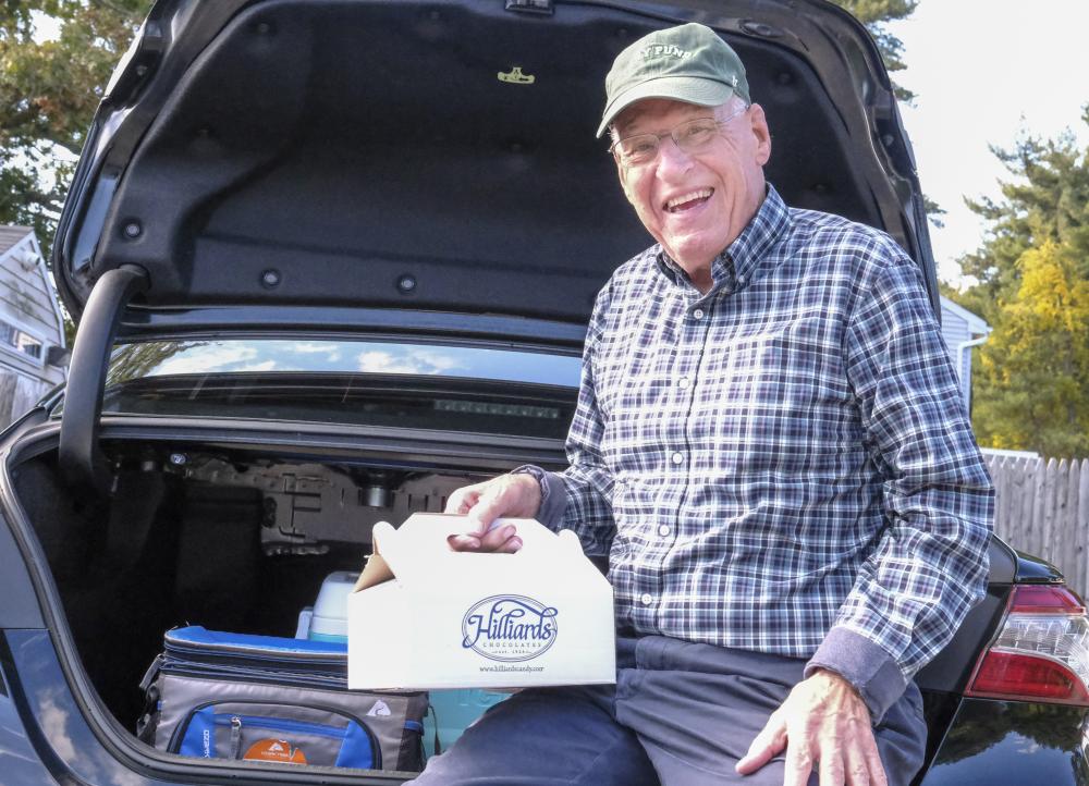 Known as the “Candyman”, Lakeville resident Fred Reagan poses with a box of candy bars. He has sold over 150,000 candy bars to fund cancer research at the Dana-Farber Cancer Institute. Photos by Sam Tucker NONE