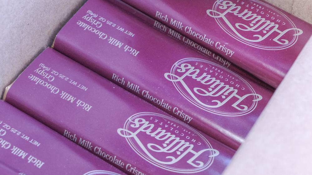 A box of candy bars rests cooly in a cooler in the trunk of Reagan's car. He said he always travels with a couple coolers packed full of chocolate to sell. NONE