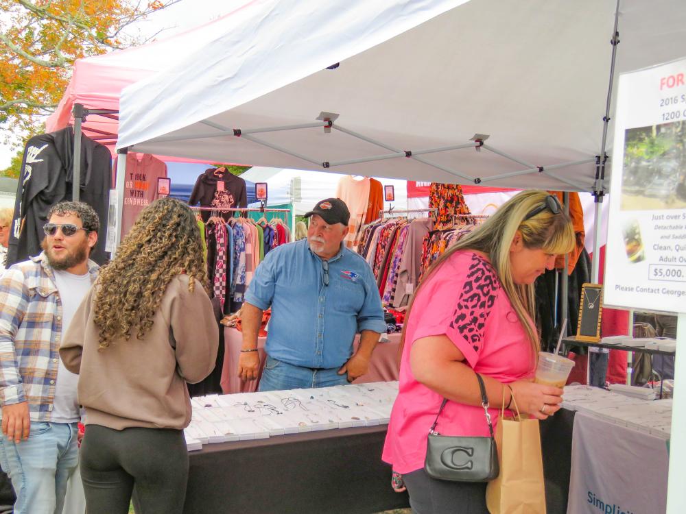 Shoppers browse jewelry by one of the vendors at Crantoberfest in front of Middleboro Town Hall Oct. 11. Photos by Grace Roche Shoppers browse jewelry by one of the vendors at Crantoberfest in front of Middleboro Town Hall Oct. 11.