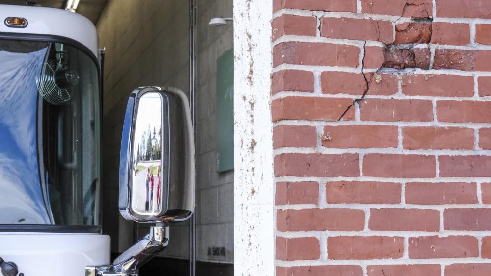 A portion of the brick facade is broken from past collisions with apparatus. NONE