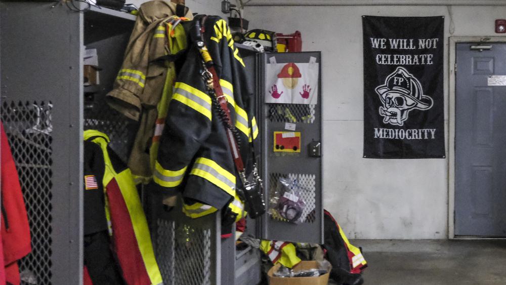 A motivational banner hangs in the crew-locker room at the station. NONE