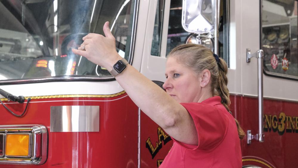 Deputy Chief Pam Garant waves in an ambulance as it parks in the engine bay. NONE
