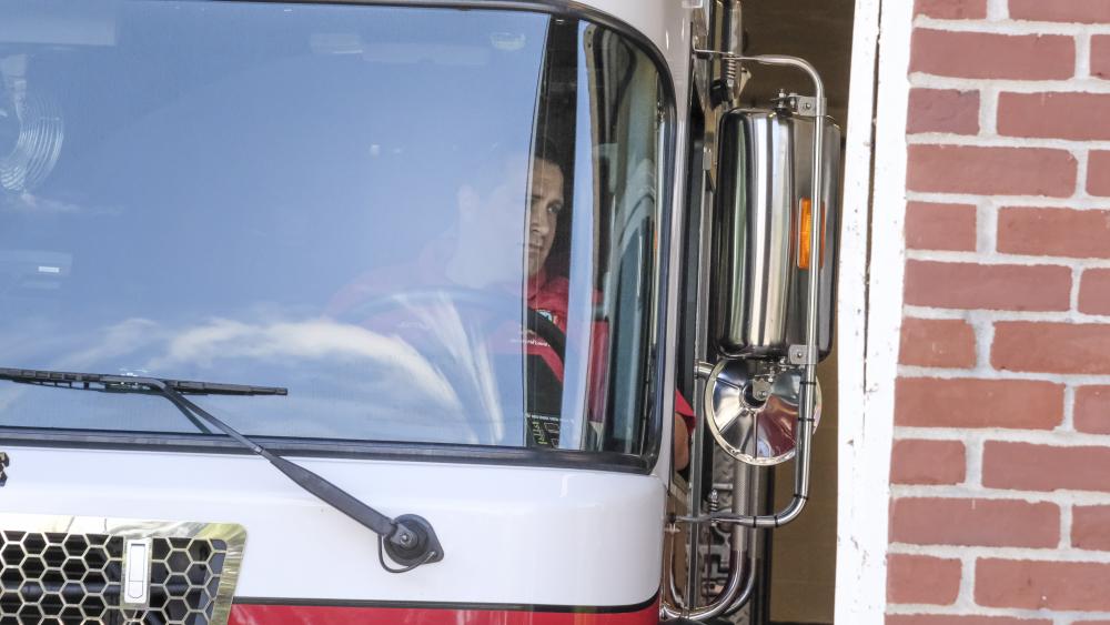 Robert Clemens eyes a sideview mirror while he parks. NONE