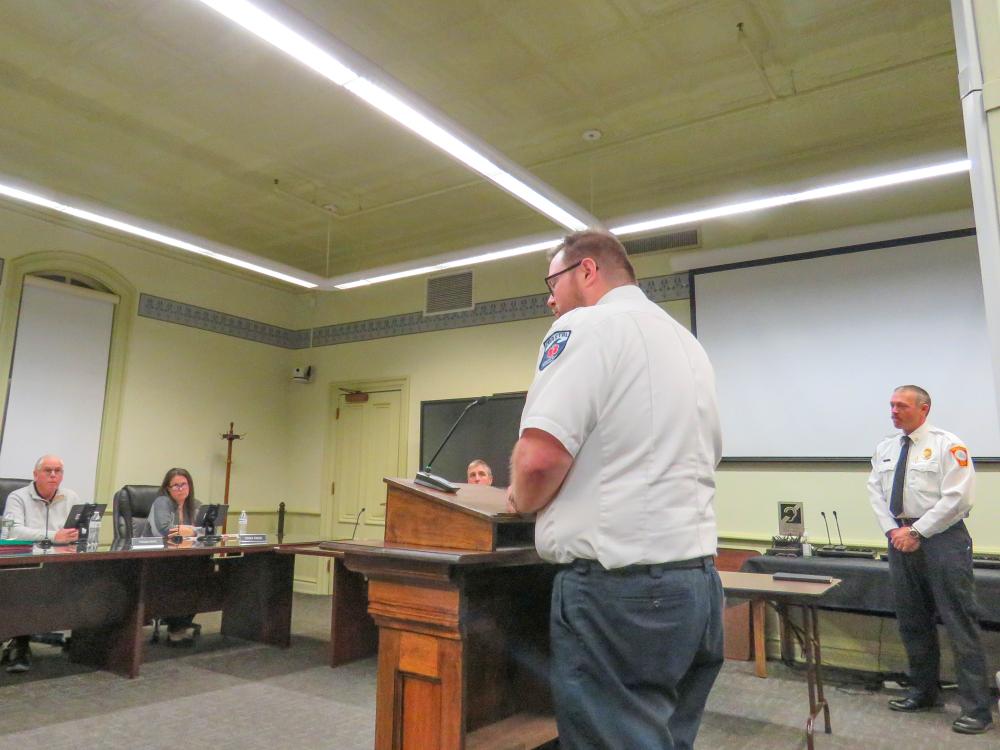 Michael Pieretti, the Coastal Medical Transportation quality officer, speaks to the Select Board while Fire Department Chief Owen Thompson looks on.  Michael Pieretti, the Coastal Medical Transportation quality officer, speaks to the Select Board while Fire Department Chief Owen Thompson looks on.