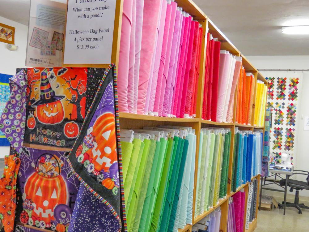 Panels of colorful fabric line the shelves of Medeiros’ store. Panels of colorful fabric line the shelves of Medeiros’ store.