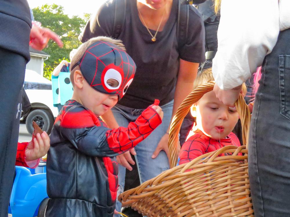 Two boys dressed as Spider-Man pick candy from a basket at Ted Williams Camp during the trunk or treat Oct. 19. Photos by Grace Roche Two boys dressed as Spider-Man pick candy from a basket at Ted Williams Camp during the trunk or treat Oct. 19.