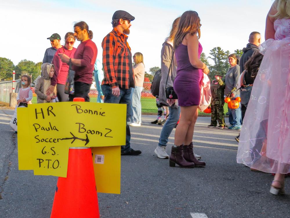 A sign tells trunk or treaters where to find the displays of various groups. A sign tells trunk or treaters where to find the displays of various groups.