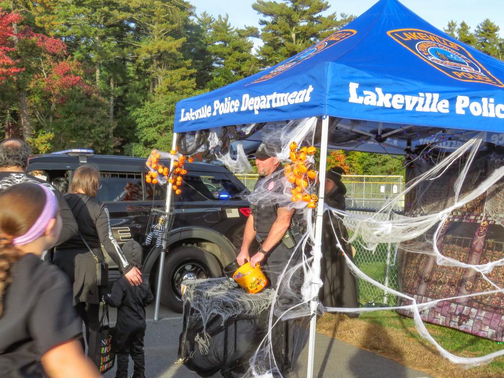 Lakeville Police officer Adam Swift hands out candy at the trunk or treat event. Lakeville Police officer Adam Swift hands out candy at the trunk or treat event.