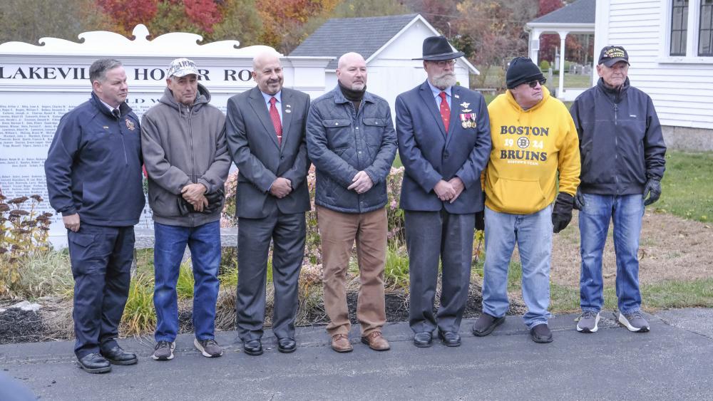 Veteran members of the crowd pose together during the ceremony.