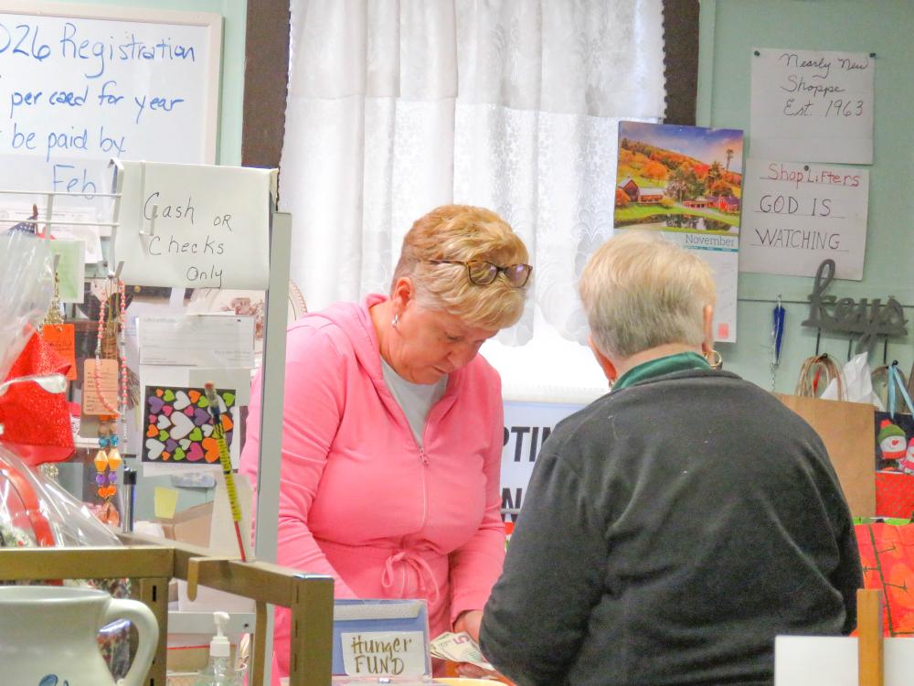 One of the longtime volunteers at Nearly New Thrift Store rings up a customer on Nov. 20. Photos by Grace Roche