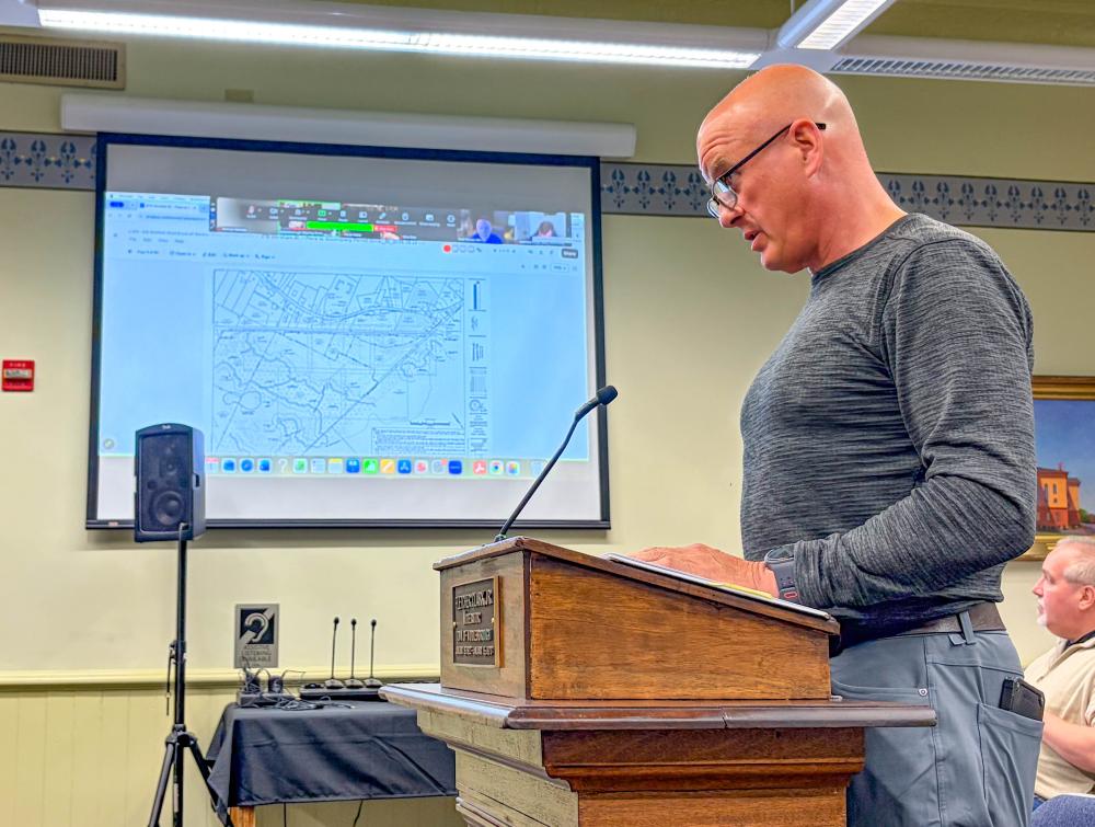 Michael Milanoski, who represents the warehouse project team, speaks at an Oct. 2 Conservation Committee meeting. Photo by Christian Uva