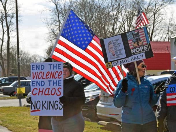Protesters with the American flag behind them.