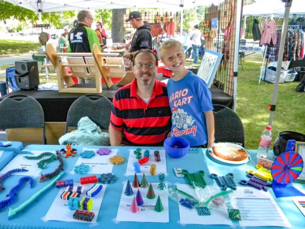 Tristan McPhee, 9, and his father, Gary, at the T's 3D booth. Photo by Christian Uva