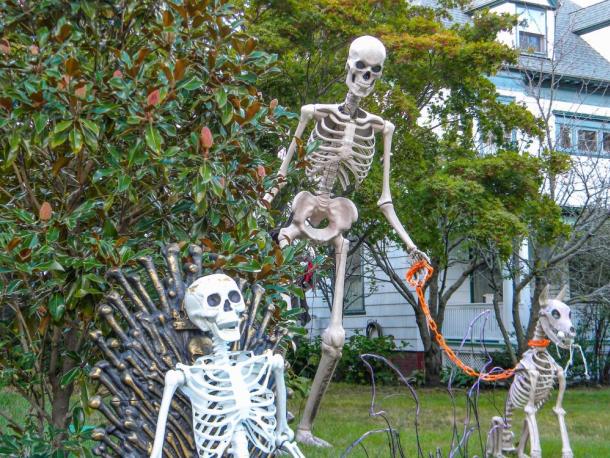 A skeleton watches over S Main St. from his throne, while another peers over its shoulder with its dog. Photo by Christian Uva