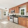Kitchen with wood cabinets, a gas range and stainless dishwasher at 17 Beeden Road, Westport, MA