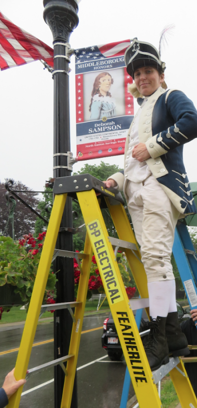 A reenactor places the banner of Deborah Sampson. Courtesy photo