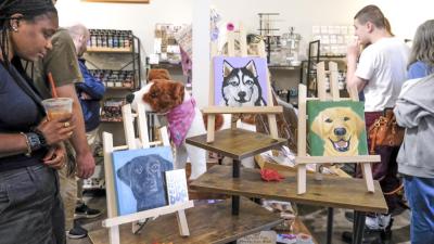 Customers shop through the boutique after the ribbon cutting ceremony on Saturday. ART
