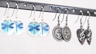 Earrings hang on a display. McRae said of the roughly 32 vendors who sell at the boutique, almost all are area-artisans. ART