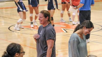 Apponequet Lakers Head Coach Megan Giammolvo laughs with the team after a timeout.