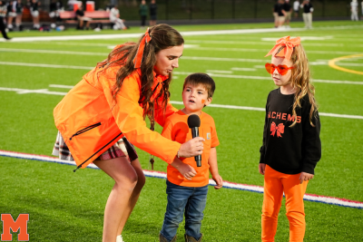 From Left: Kindergarten teacher Carly Paling and students Collin Bertram and Willow Norvish speak during the Middleboro meet at the 50 event. 