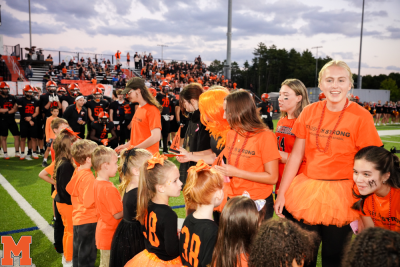 Senior and kindergarden students meet in the middle of the Middleboro High School football field Sept 19. 