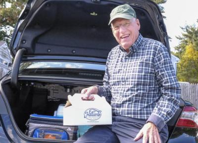 Known as the “Candyman”, Lakeville resident Fred Reagan poses with a box of candy bars. He has sold over 150,000 candy bars to fund cancer research at the Dana-Farber Cancer Institute. Photos by Sam Tucker NONE