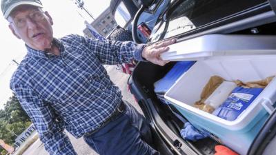 Reagan shows the coolers he keeps stocked full of candy bars from the New England-based Hilliards Chocolates company. NONE