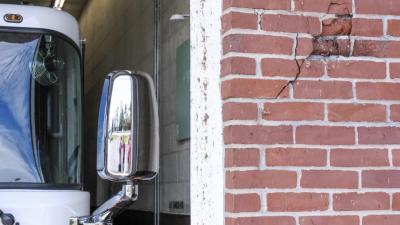 A portion of the brick facade is broken from past collisions with apparatus. NONE