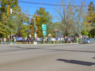 Protesters stand on a street corner during the protest Saturday. Protesters stand on a street corner during the protest Saturday.