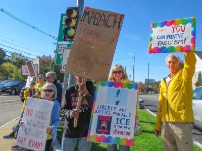 Protest attendees show off their signs. Protest attendees show off their signs.
