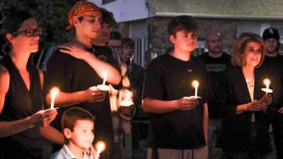Amy Nadolny's eldest son, Kaiden Machado, second from left, listens to longtime friends of Nadolny share stories and speak on his mother's character and impact she has left on others. NONE