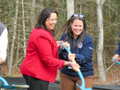 Driscoll (left) and Select Board member Teresa Farley break ground on the project together. 