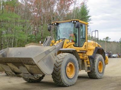 A bulldozer drives through the construction site. 