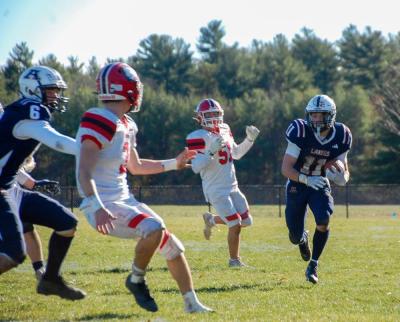 Joseph Procaccini runs the ball on the sideline.