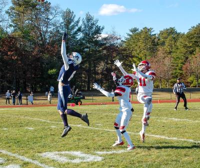 Colin Cyr leaps for the ball before defenders get it.