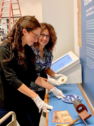 Ariel Hansen, left, and Larissa Hansen-Hallgren work together to assemble a new exhibit for the Lexington History Center in Lexington, Kentucky. Photo source: Larissa Hansen-Hallgren