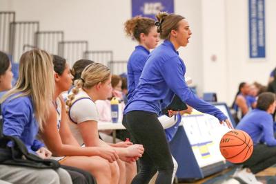 Alexandria Petit, right, coaches from the sideline during an Ursuline College women's basketball game. Photo source: Alexandria Petit