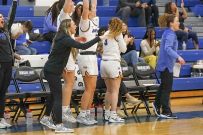 Petit, front, cheers with Ursuline players during a game. 