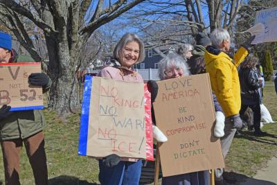 Two protesters pose with their signs.