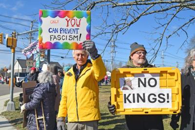 Two protesters ask for no kings and no fascism. 